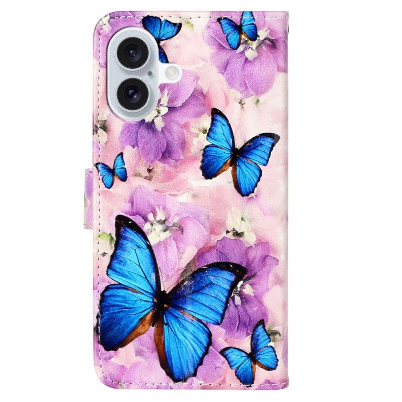 Lederhüllen iPhone 16 Blaue Schmetterlinge Und Lila Blumen Mit Riemen