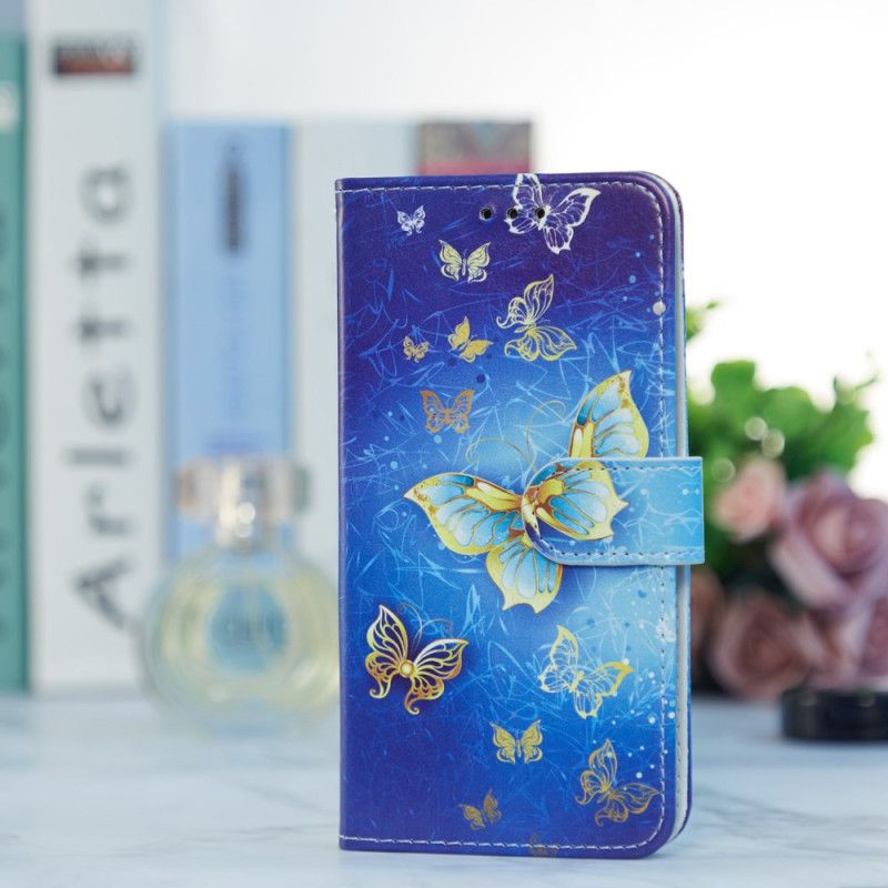 Lederhüllen Samsung Galaxy A55 5g Goldener Schmetterling Auf Blauem Hintergrund Mit Riemen